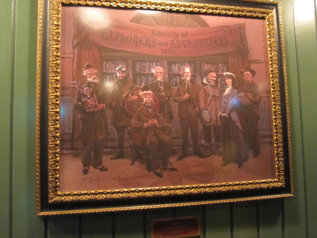 Drawing of Mystic Manor ride creators as explorers and adventurers in waiting room