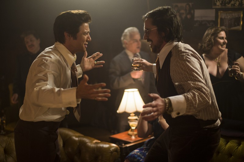 Jeremy Renner (Mayor Carmine Polito) and Christian Bale (Irving Rosenfeld) in American Hustle