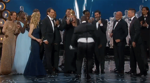 Director Steve McQueen jumping on the Oscar stage in joy after 12 Years a Slave wins Best Picture
