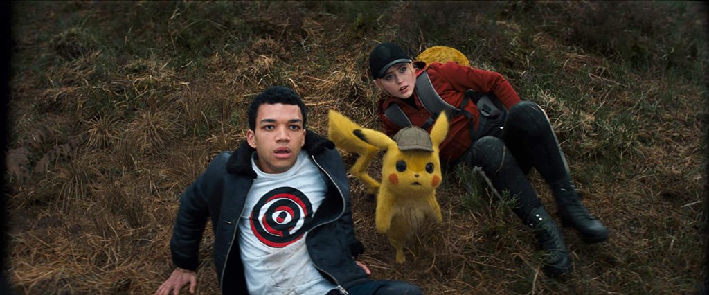 Justice Smith (Tim Goodman), Pikachu (Ryan Reynolds) and Kathryn Newton (Lucy Stevens) in Pokémon Detective Pikachu