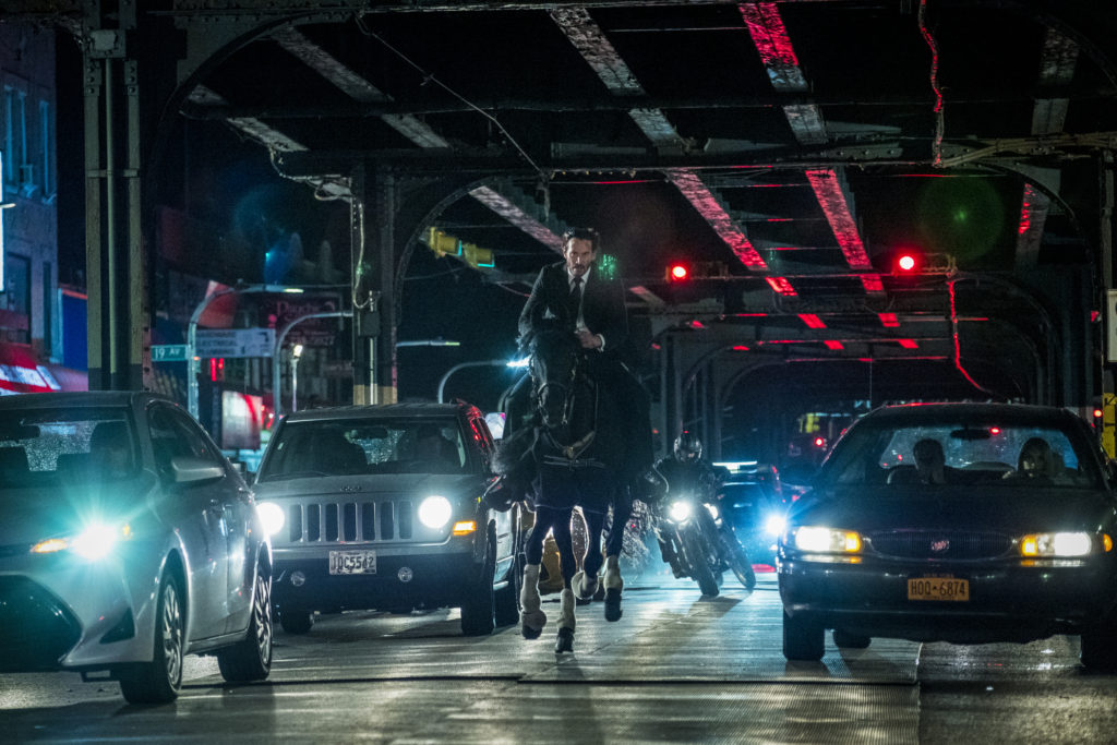 John Wick 3 review: Keanu Reeves as John Wick riding a horse through the streets of New York in John Wick: Chapter 3 – Parabellum